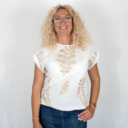 Blusa blanca con hojas doradas y cuello redondo